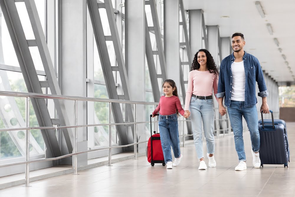 mother, father and little daughter going to boarding, enjoying traveling together