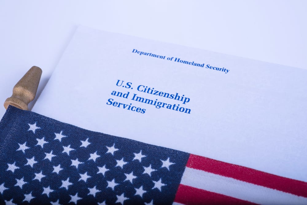 The envelope with Logo from US Citizenship and Immigration Services - USCIS (Department of Homeland security) near the Flag of United States of America
